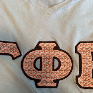 Gamma Phi beta blue v-neck block letter shirt.
